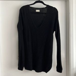 From Aritzia: the line is from Wilfred Free black knitted sweater. Slightly worn